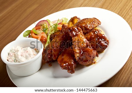 Roasted chicken wings on plate.Shallow depth-of-field.