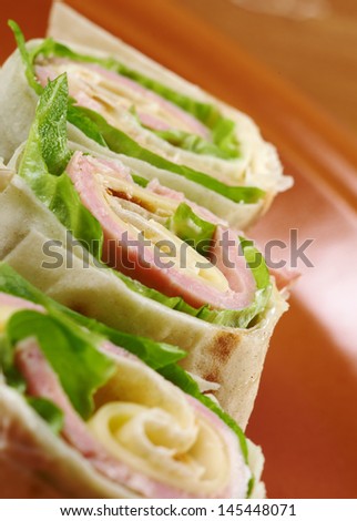 healthy club sandwich pita bread roll with cheese,ham,parsley