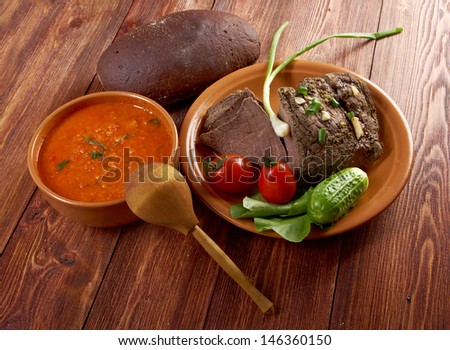Italian rustic dinner -  tomato soup or Pappa al Pomodoro and roasted beef and vegetables with bread ,farm-style