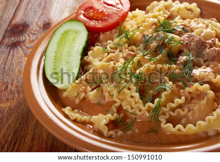Italian pasta mafalde with  beef ,sour cream and  tomato sauce