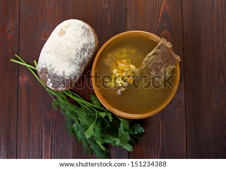 Pea soup with beef ribs  and farmhouse bread,edible greens .farmhouse kitchen