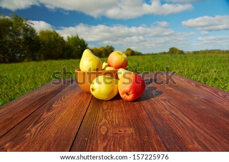 fruit on a wooden table.Background blue sky.Outdoor farm-style