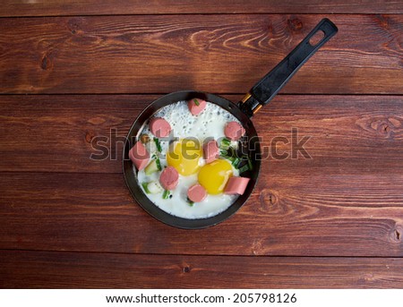 fried eggs with  sausages in a frying pan .breakfast bachelor