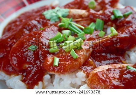 Shrimp Creole -  dish of Louisiana Creole origin .cooked shrimp in mixture  tomatoes,  celery and bell pepper, spiced  and served  boiled white rice