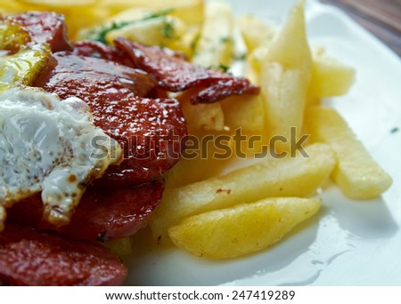Chorrillana -  Chilean dish consisting of a plate of french fries topped with beef sliced into strips, eggs, fried onions and occasionally sausages.