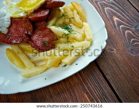 Chorrillana -  Chilean dish consisting of a plate of french fries topped with beef sliced into strips, eggs, fried onions and occasionally sausages.
