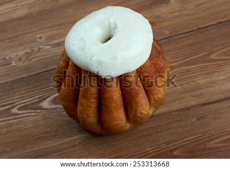 Rum baba  on wooden background. cake saturated in hard liquor, usually rum, and sometimes filled with whipped cream or pastry cream.