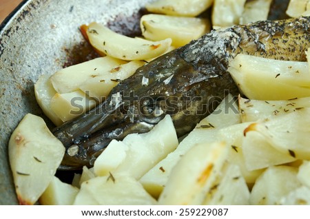 Baked pike with potatoes.home cooking.country cuisine