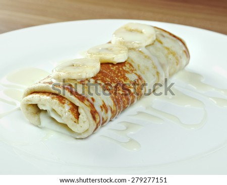 stuffed pancakes with sweet sauce and bananas