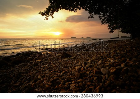 Dramatic sunset and sun beam at a sea in Thailand
