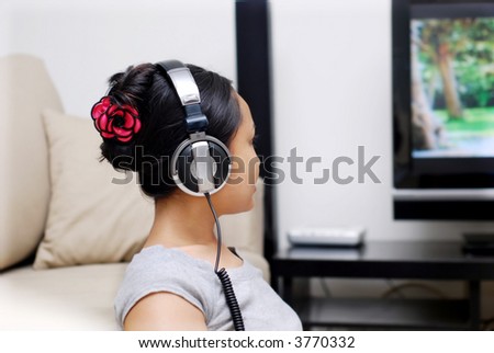 Women listening to music while watching TV