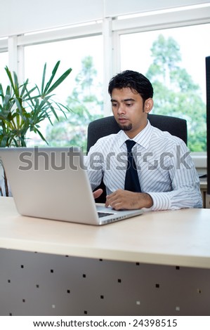 Asia male executive working on laptop
