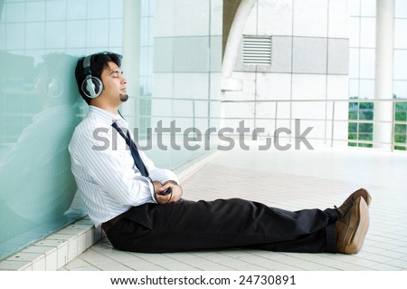Corporate man enjoy the music