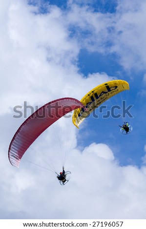 PUTRAJAYA, MALAYSIA - MARCH 21:  Motor powered paragliders fly at the first International Hot Air Balloon fiesta in Putrajaya on March 21, 2009 in Putrajaya, Malaysia.