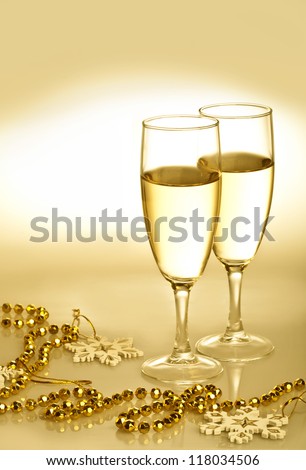 Champagne glasses with gold ornaments and snowflakes
