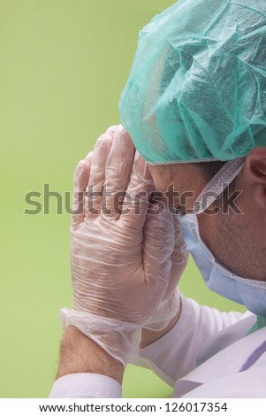 Surgery Doctor Praying on Green Background