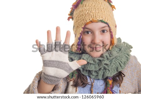 Beautiful young girl in warm winter clothes showing hi five