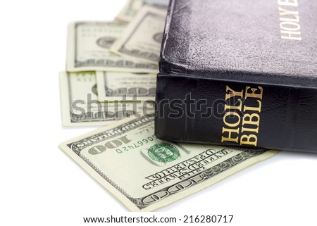 Holy Bible and money Hundred dollars Isolated on white background Holy Bible and money Hundred dollars Isolated on white background