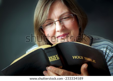 Adult Woman Reading a Bible. Close