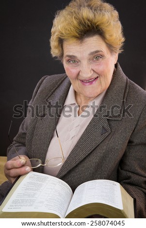 Senior woman reading holy bible. Woman with glasses