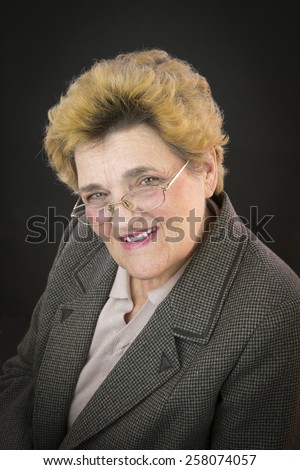Portrait of senior woman with green eyes and glasses