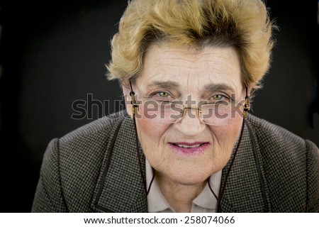 Portrait of senior woman with green eyes and glasses