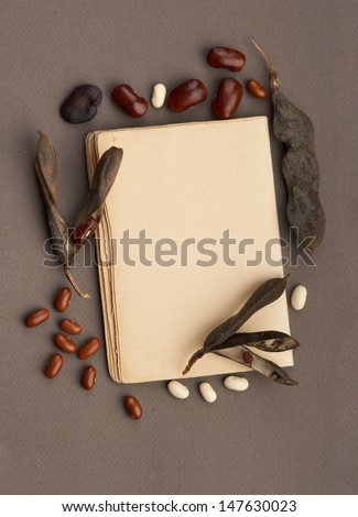 Old paper with bean pods and bean seeds. Vintage still life.