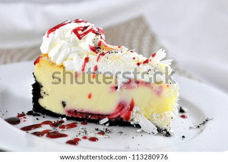 Raspberry cheesecake with drizzle of raspberry sauce.