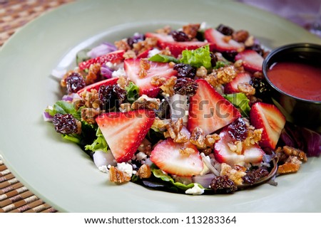 Strawberry Salad - Strawberries, feta cheese, red onion and candied nuts with dried cherries.