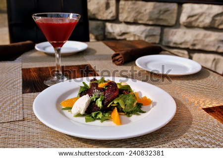 Beet salad with arugula, orange, roasted beets and goat cheese mousse with beet vodka martini.