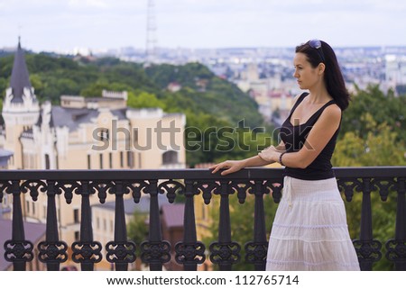 the girl looks into the distance to the city