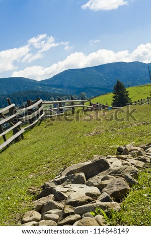 the fence in the mountains in the summer