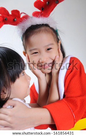 two happy asian child in christmas costume hugging;Christmastime, New Year holiday concept