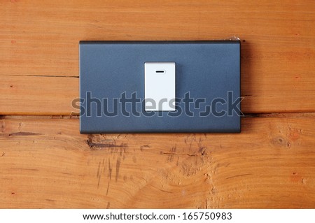 electric light switch on aged old wood wall