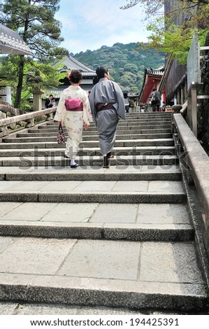 KYOTO,JAPAN - April 18,2014: Young japanese yukata couple in traditional kimono walk together to the shrine in their cultural worship.