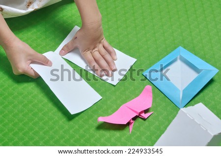 child tear paper to make origami paper craft