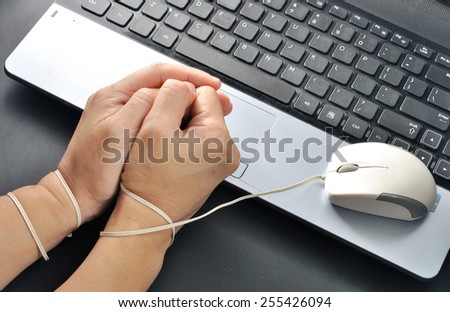 woman hand hold mouse and wrist were bond with computer mouse, computer and internet addiction concept