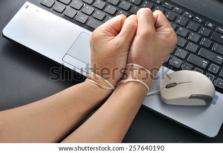 woman hand hold mouse and wrist were bond with computer mouse, computer and internet addiction concept