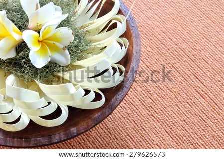 Handmade paper design decorated with plumeria flowers on wooden tray for table decoration