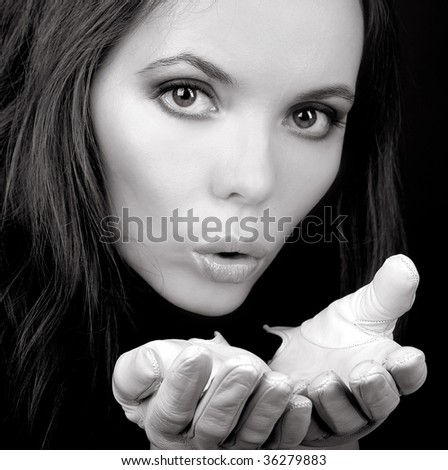Charming blowing woman in white gloves in monochrome