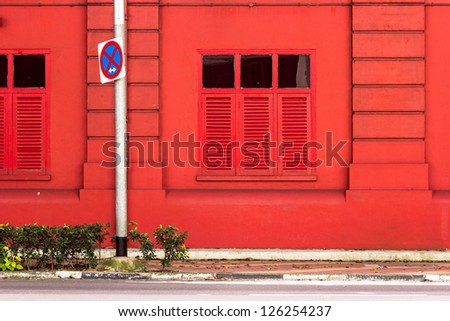 Background: Red building windows with the traffic sign