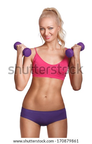 Young beautiful woman in fitness wear with dumbbells