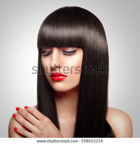 Portrait of beautiful fashion woman with long healthy brown hair and fringe hairstyle.