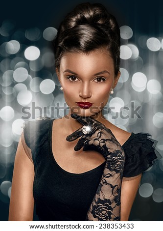Portrait of beautiful brunette smart woman wearing gloves and ring with big stone.