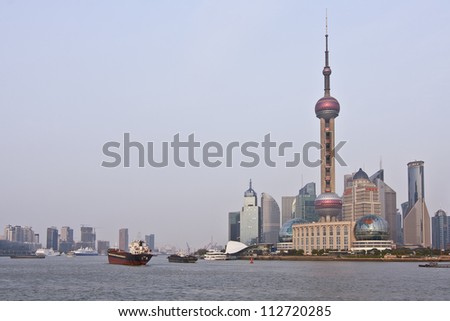 Shanghai - the largest city by population in China, and in the world. Pu dong district, by the side of Huang pu River. Oriental Pearl Tower. Shanghai Modern Architectural Design. Morning.