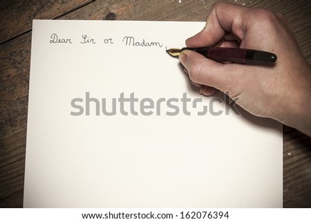Old fashioned letter with a pen in a hand