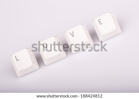 Word love formed with computer keyboard keys on white background with shadow