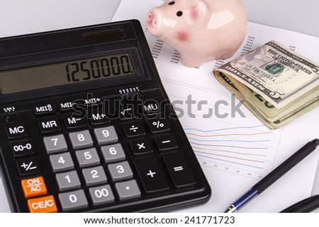 Business Charts with calculator, dollars money, piggy box or money box and pen on white background