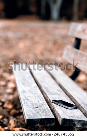Someone forgot cell phone on a bench in the park - lost phone on the bench