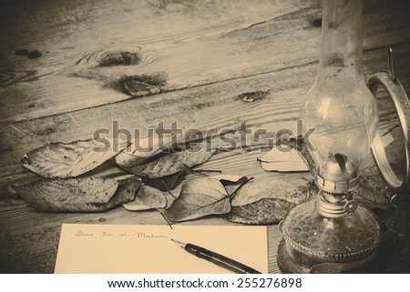 Old fashioned letter with a lamp and leafs